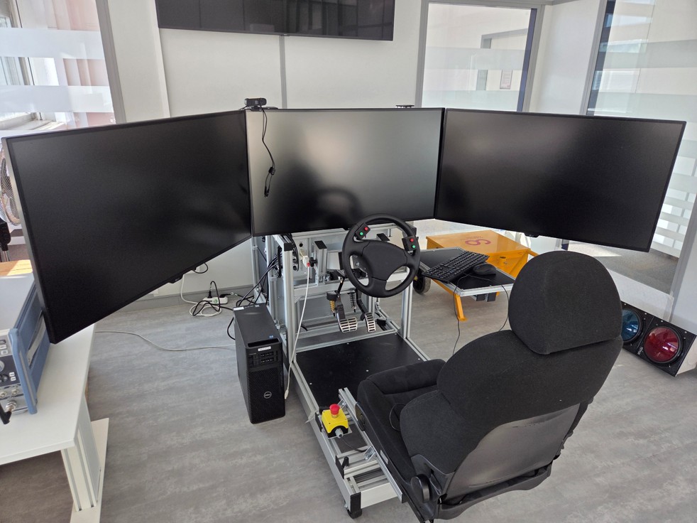 Driving simulator with triple monitors and steering wheel